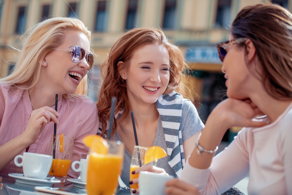A lady in a long-distance-relationship hanging out with her female friends