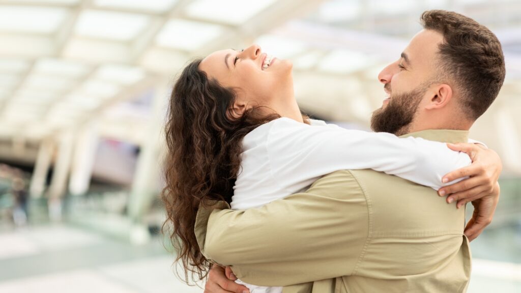 long-distance couple reuniting happily at the airport