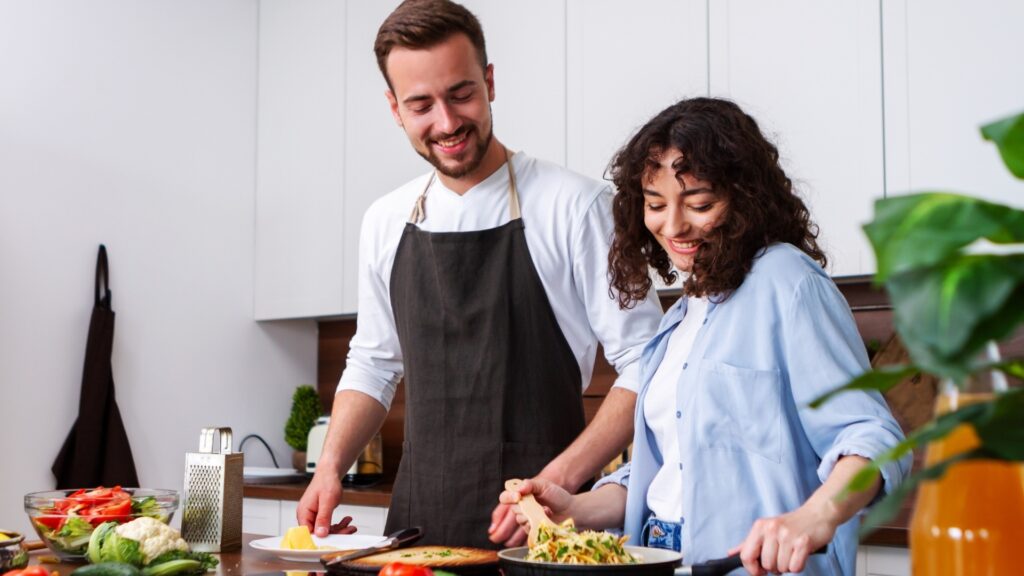 couple baking the same meal on a zoom date
