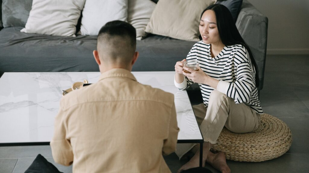long-distance couple sitting on the floor in a sitting room asking questions about each others past