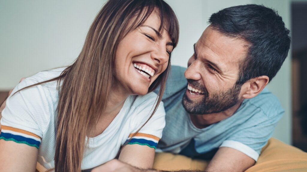 couple smiling as they plan for their next dinner date