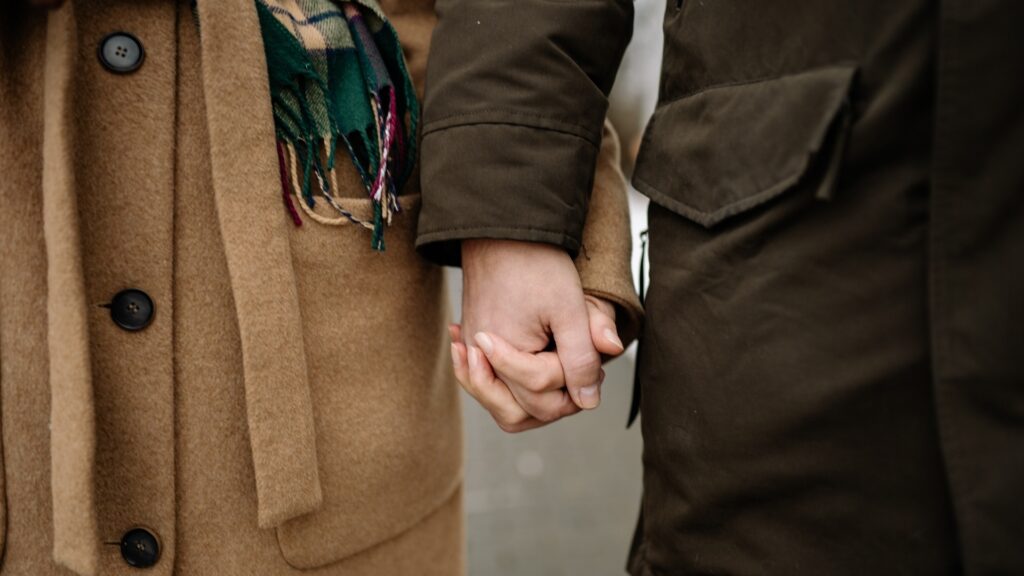 couple holding each other hands as a sign of commitment and solidarity
