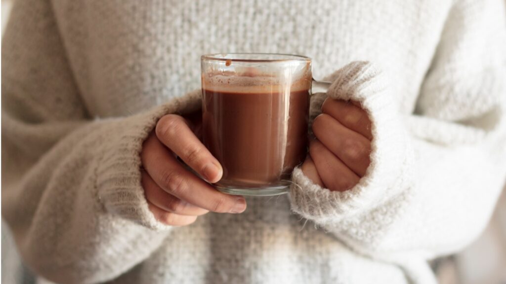lady carrying a glass of chocolate