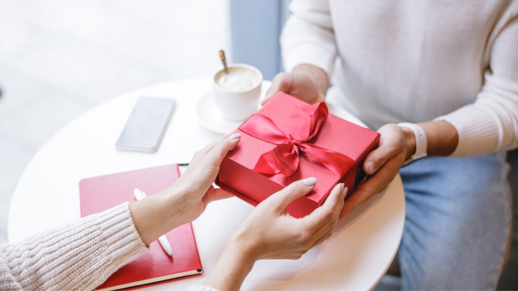 Lady receiving adventure book from long-distance partner