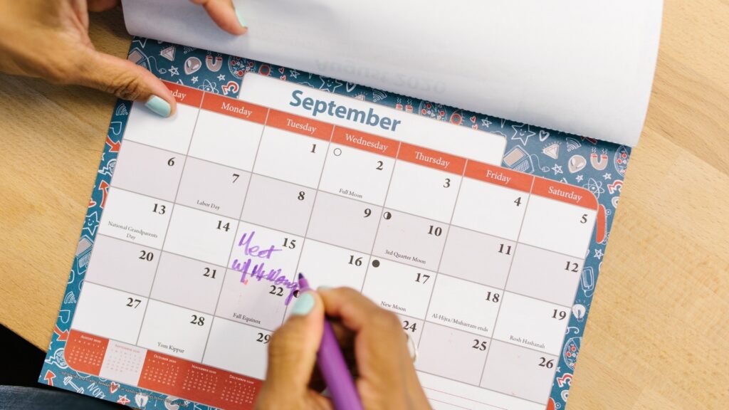 man ticking his calendar for his next visit to his girl friend