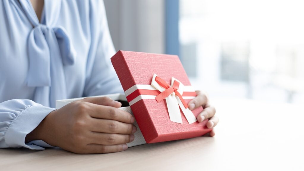 lady opening a lovely care package gotten for her by her long-distance partner
