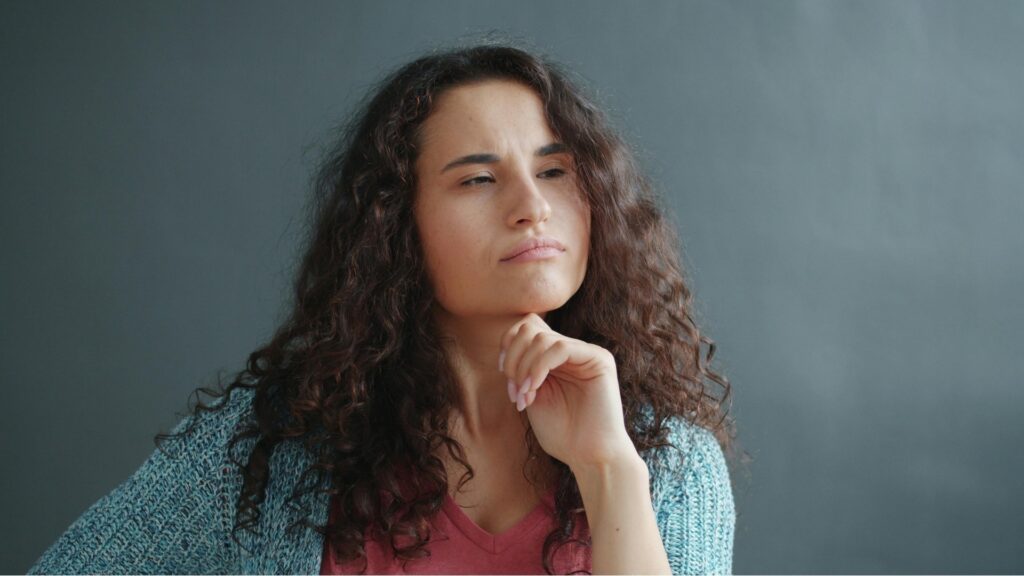 lady thinking of specific questions to ask her long distance partner