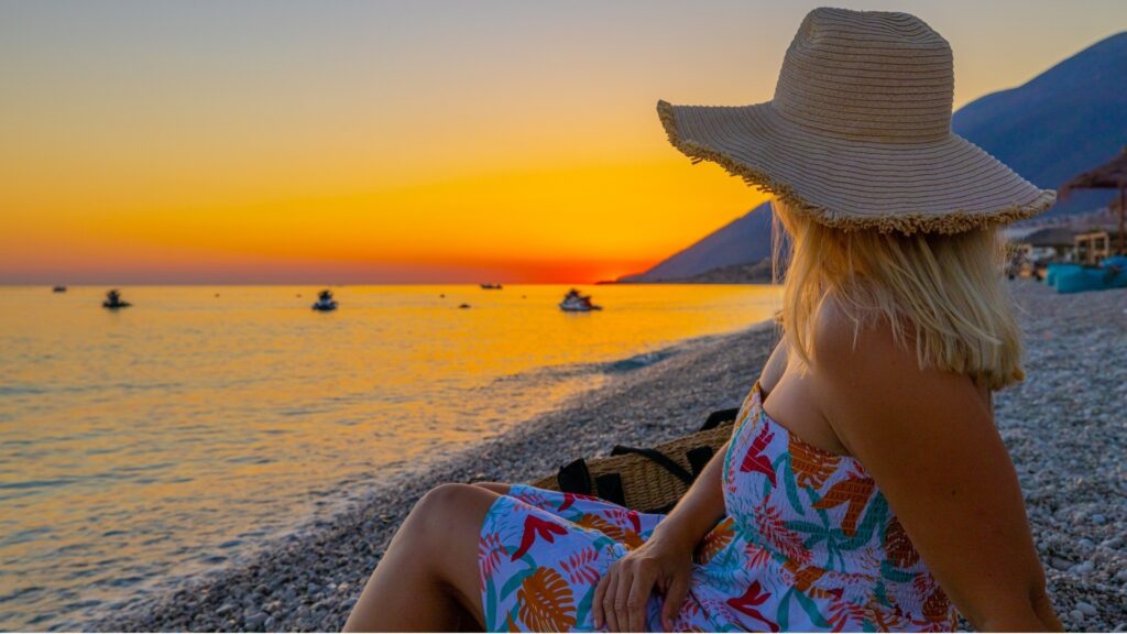 lady relaxing in a beach during summer vacation paid for by her long-distance partner