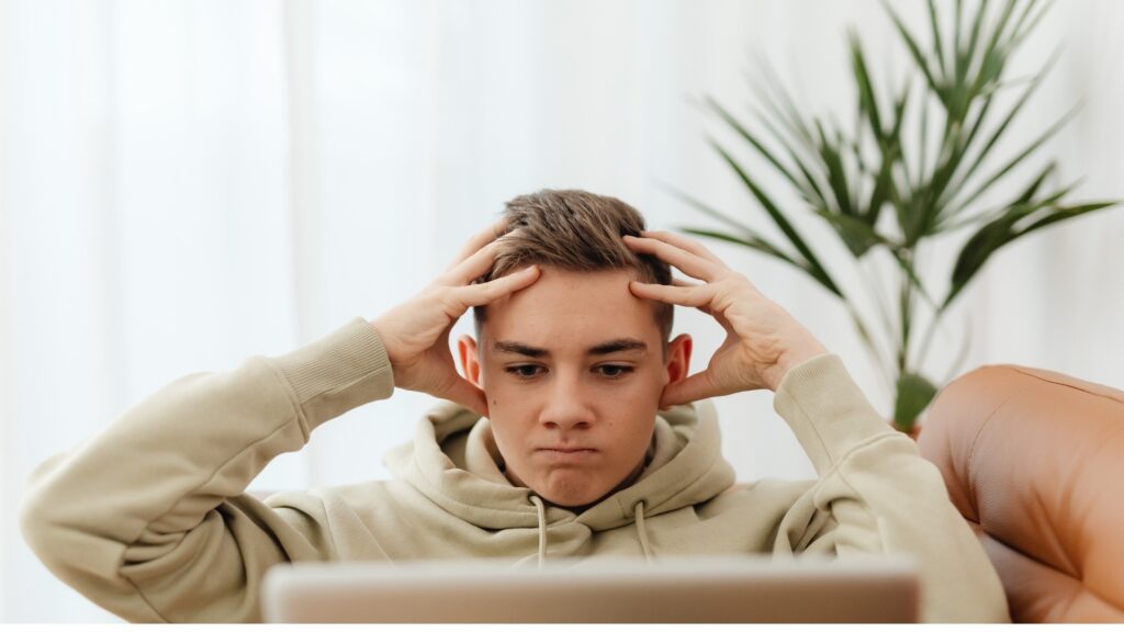 man frustrated that his long-distance partner isn't responding the way he wants