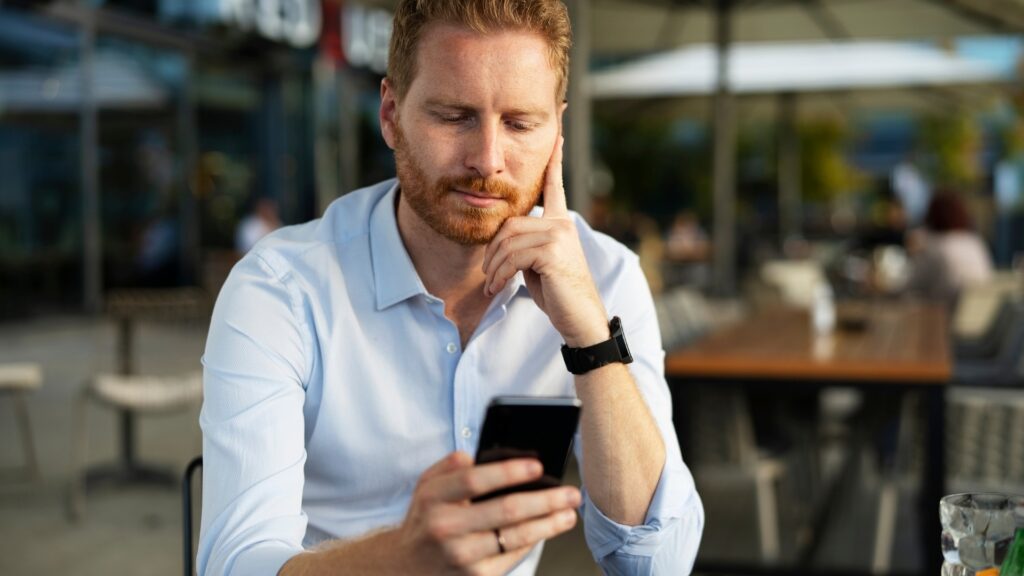man feeling sad as he watched his glong-distance partner's instagram reel on her hangout with friends