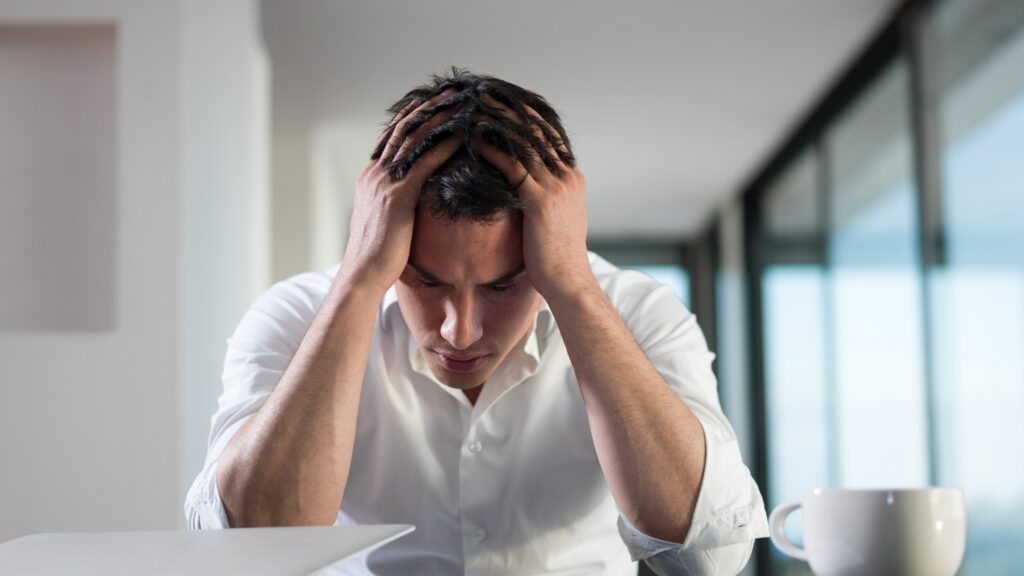 man expecting his long-distance partner's call