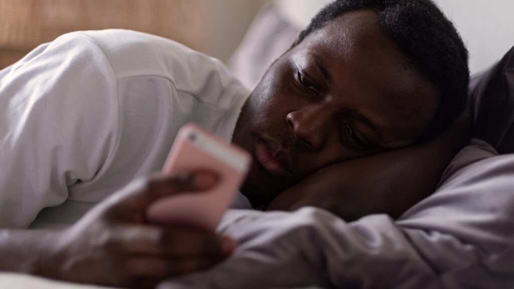 man reading early morning text message
