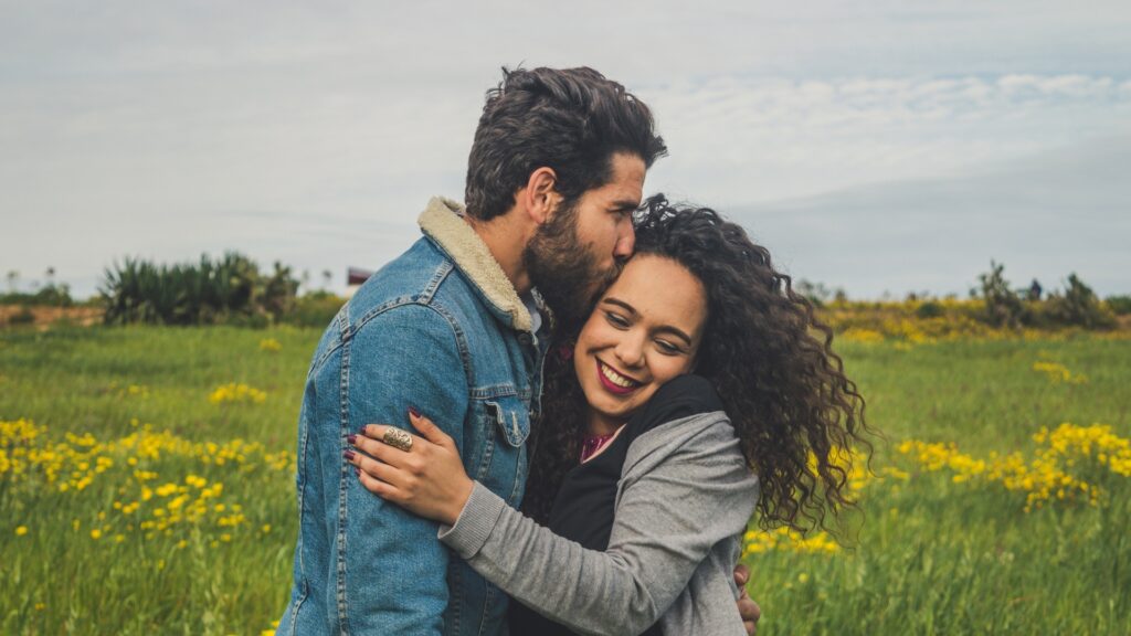 man pecking his woman after she gave an impressive answer to the question he asked her about what they share as a couple