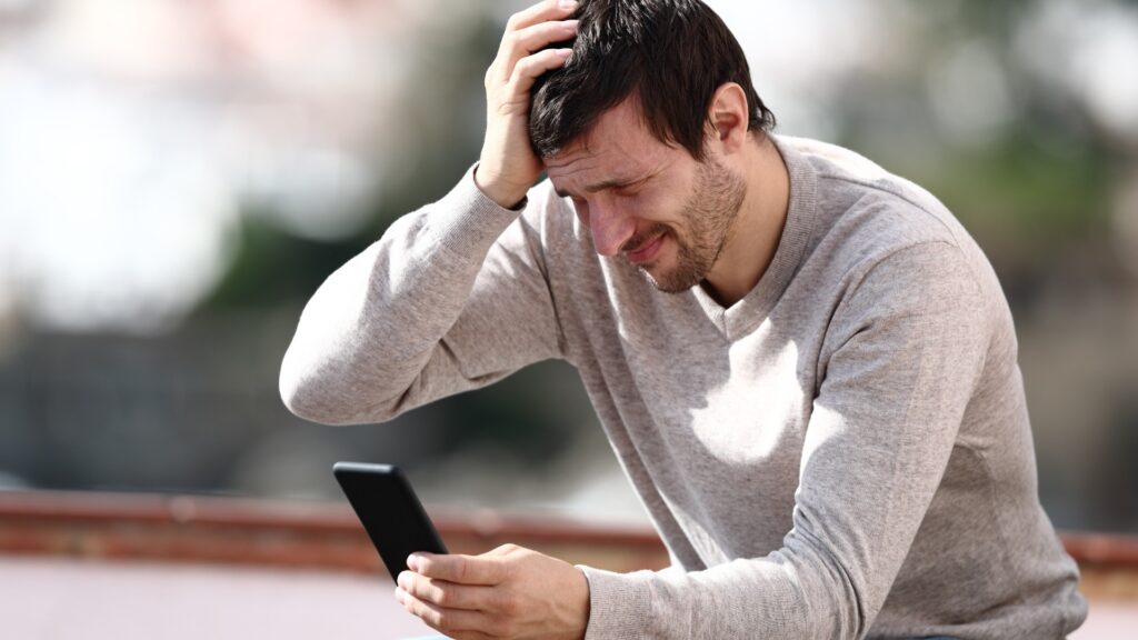 man sad because of the strain in his long-distance relationship