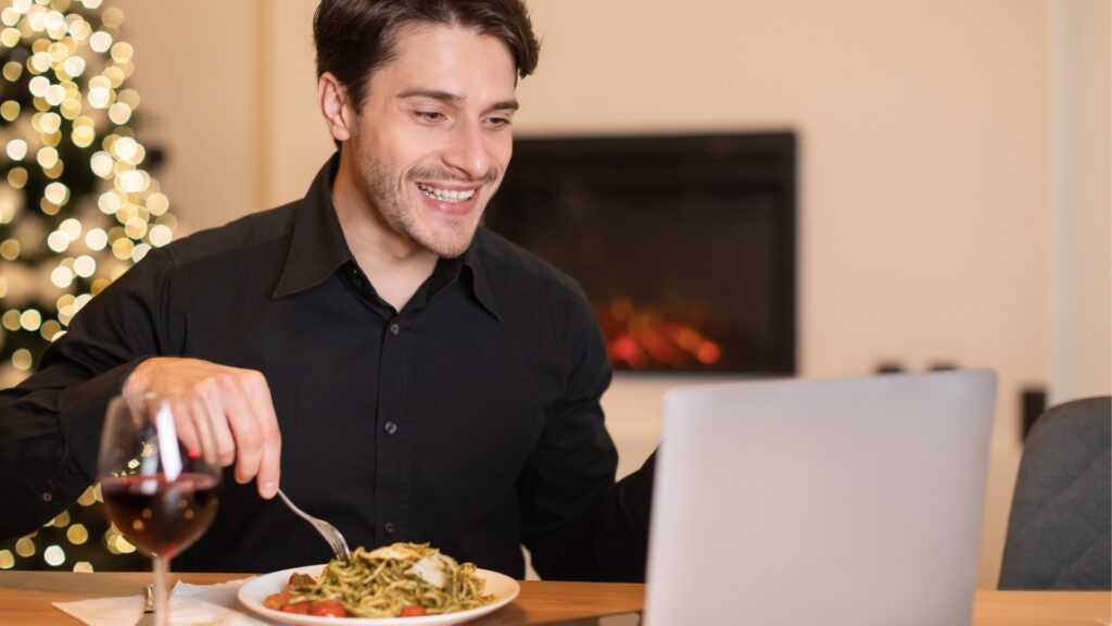 man having dinner during video call with his long distance girlfriend
