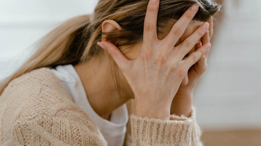 lady avoiding eye contact with long-distance partner after the argument has died down and the weight of the text she sent came starring at her