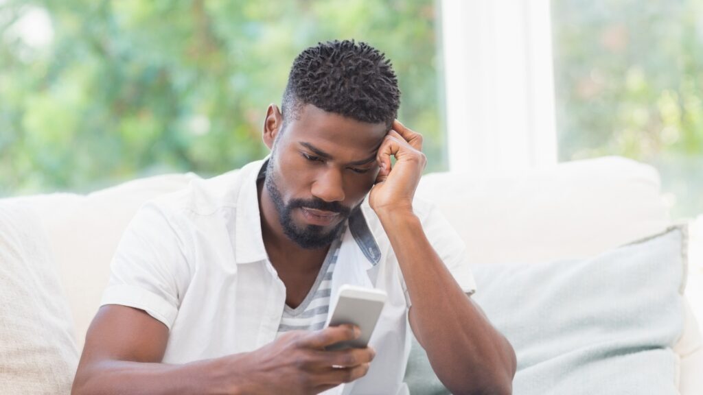 man on white shirt in desperate need for reassurance by long-distance partner