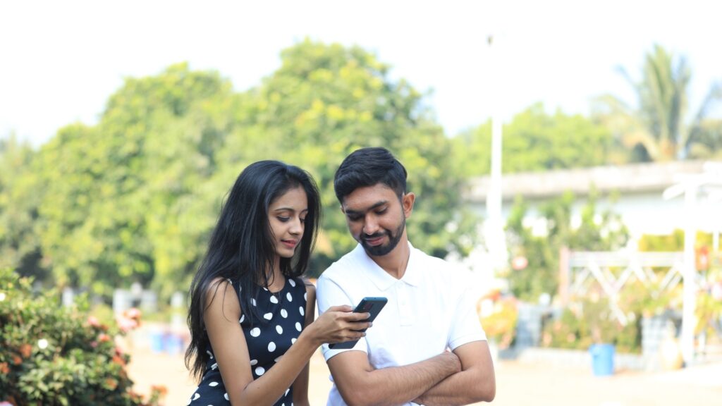 lady asking man about his view on an Instagram reel they are watching 