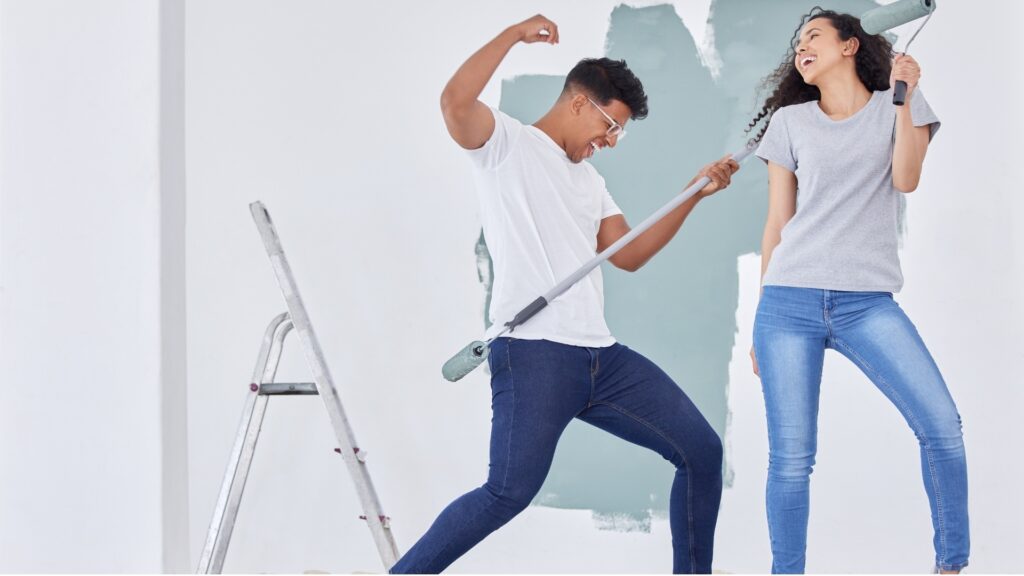 man and lady dancing to a song during their paint date