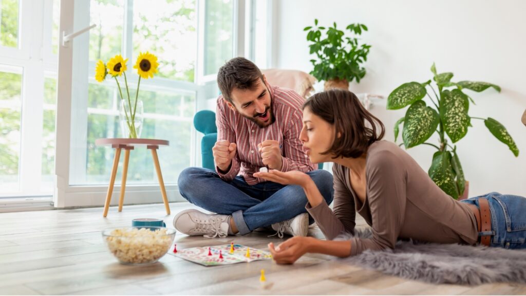 lady laying on thr floor while she asks her partner to predict something she could do
