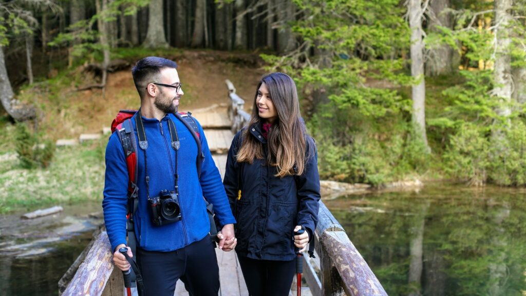 couple taking a walk across a bridge