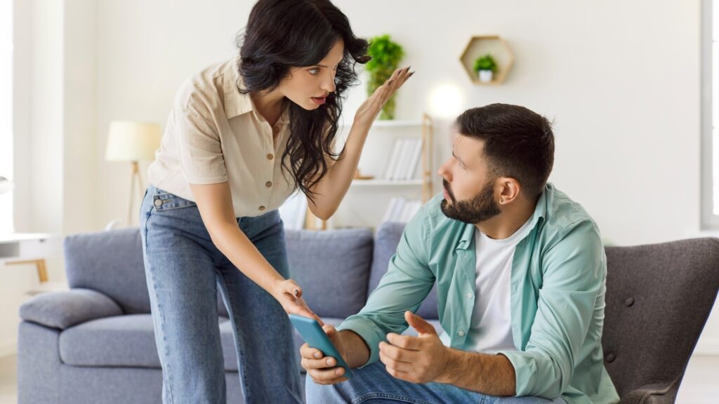 lady acosting her long distance partner over a chat she saw on his phone