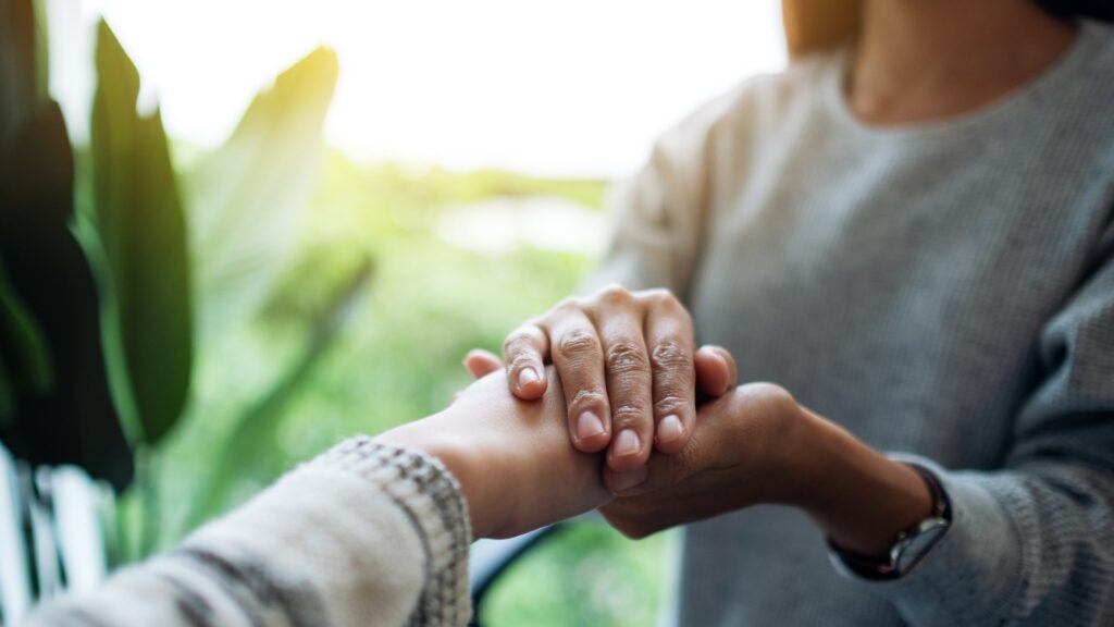 couple holding each other in a reassuring manner