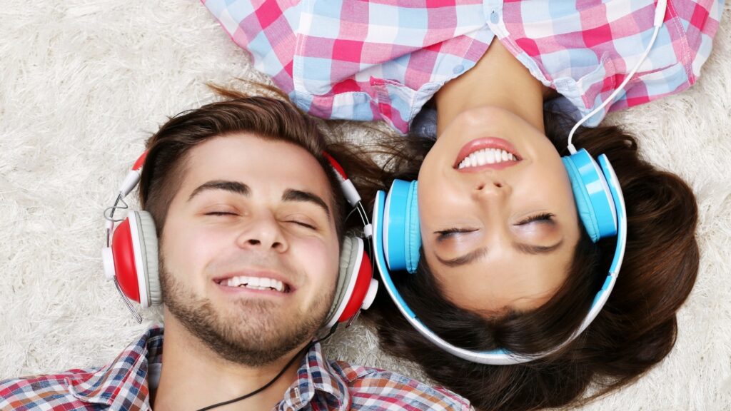 young couple vibing to their favorite Playlist during a date