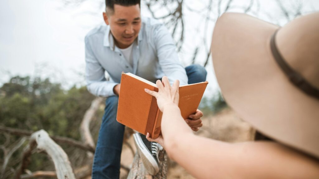 man choosing a book for her partner to read