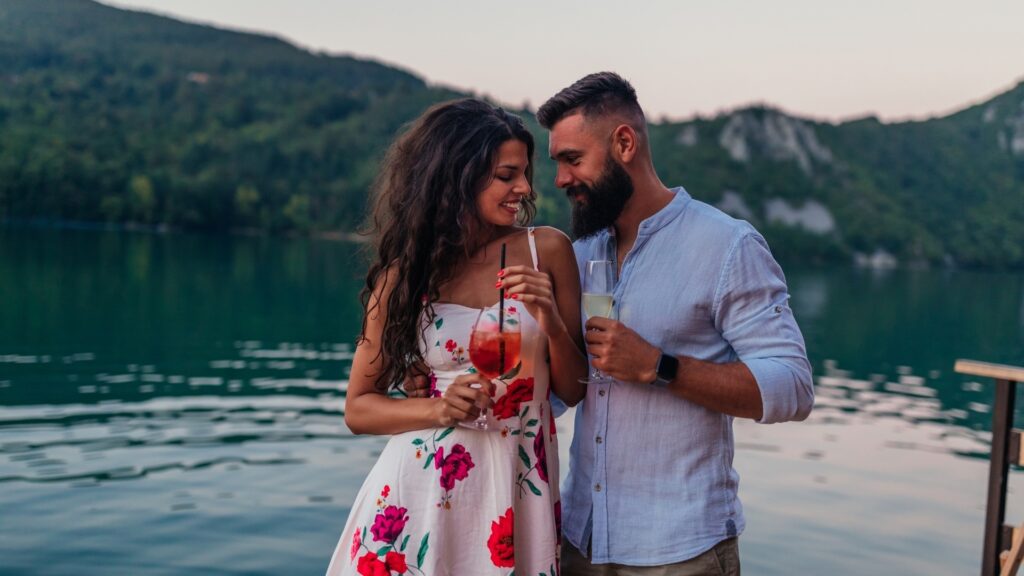 couple taking a walk on the beach side while they talk about the book they just read

