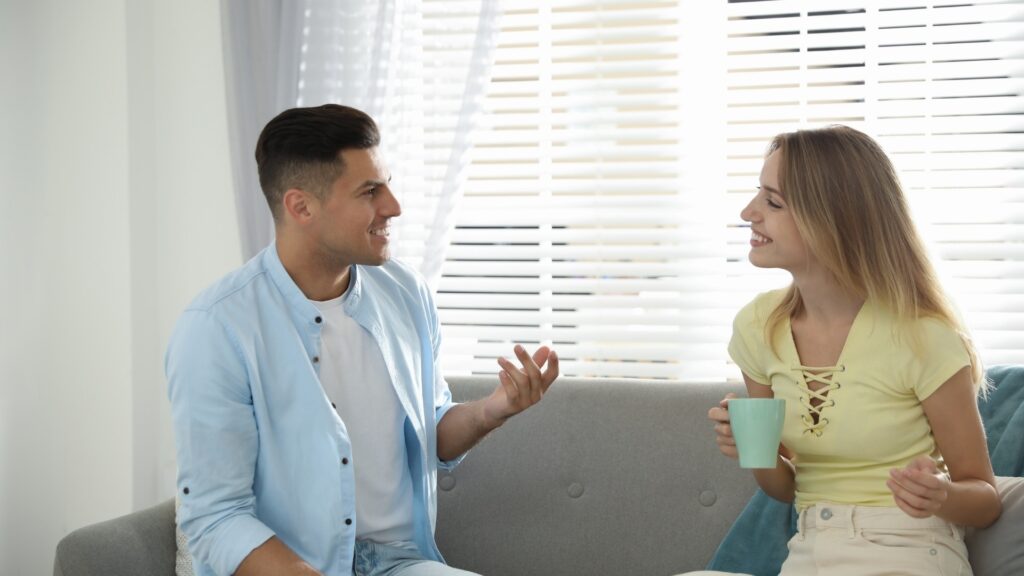 lady on yello polo talking to her long-distance partner on a skyblue shirt about what she feels finally closing the distance between them
