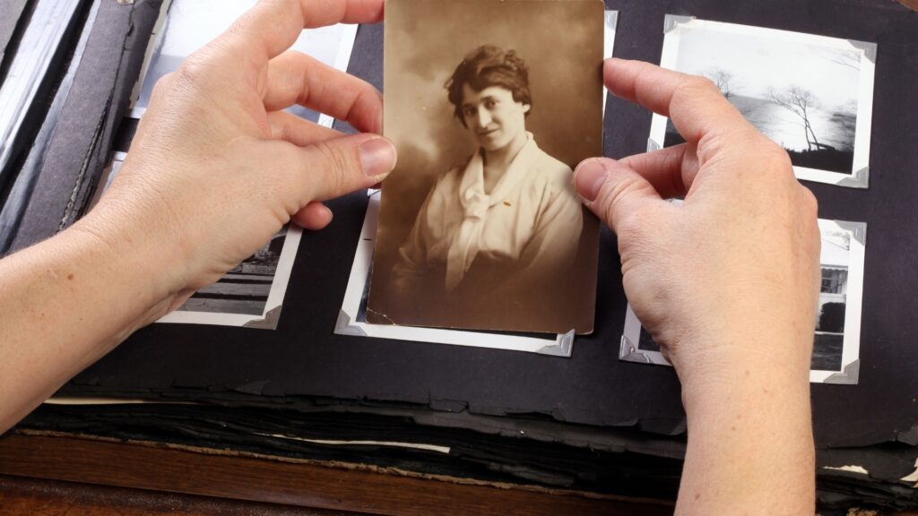 man holding a photograph in hand
