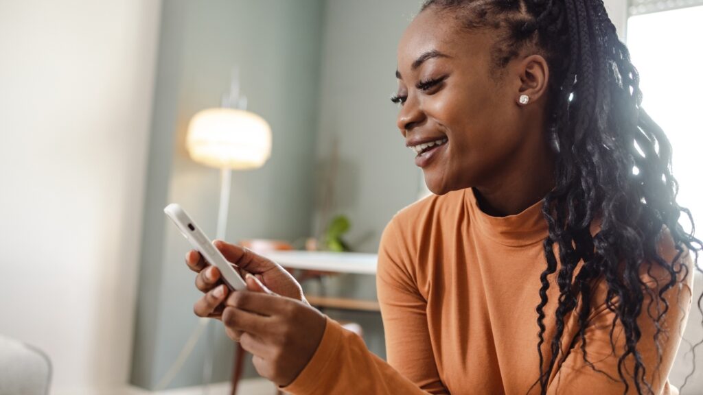 woman smiling as she understood the context of the text she read