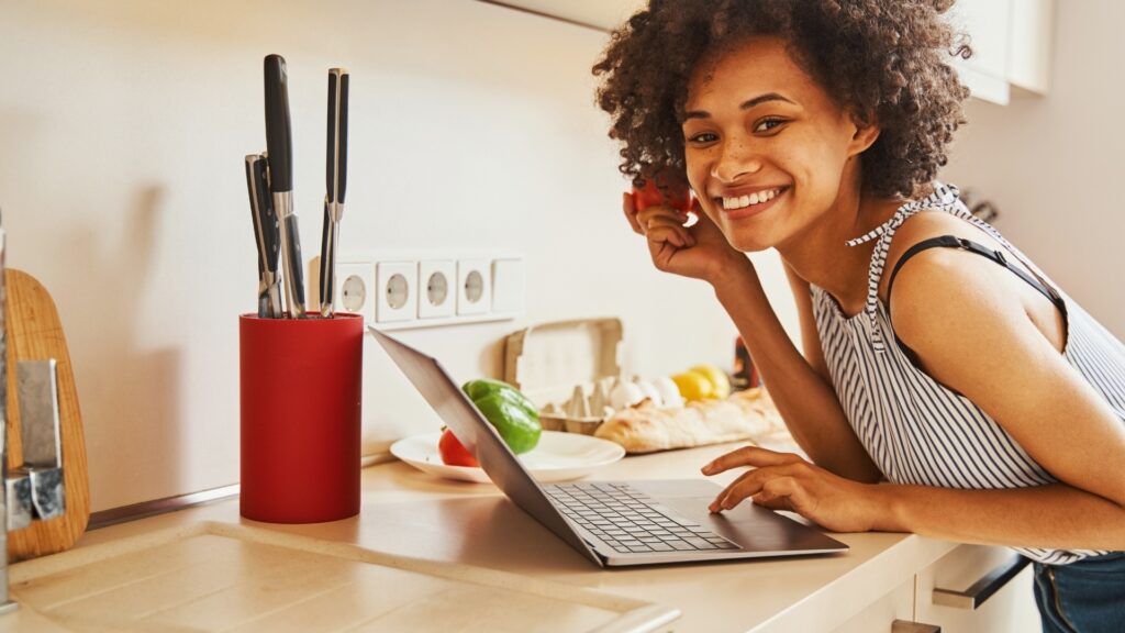 lady smiling at her boy friend while cooking