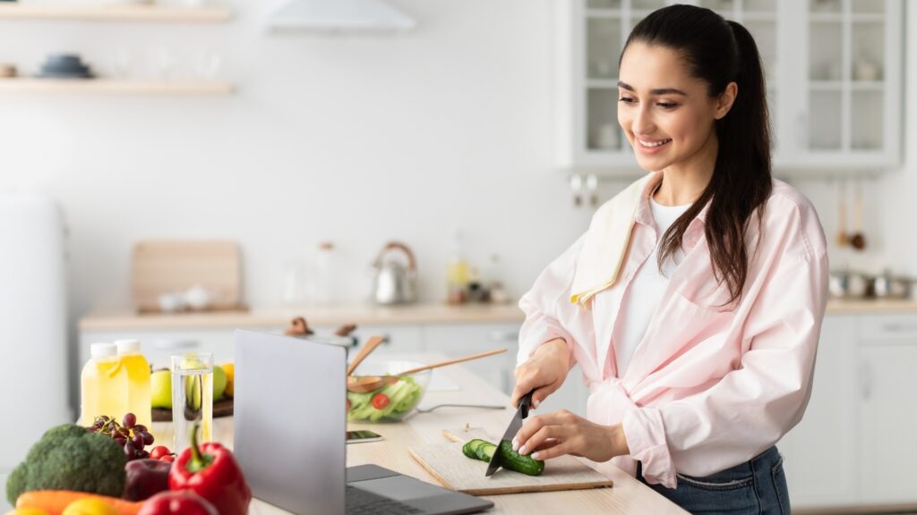 lady cooking her favorite meal with her long distance boyfriend over video