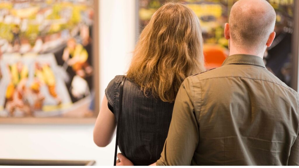 couple taking a look at an object in a museum