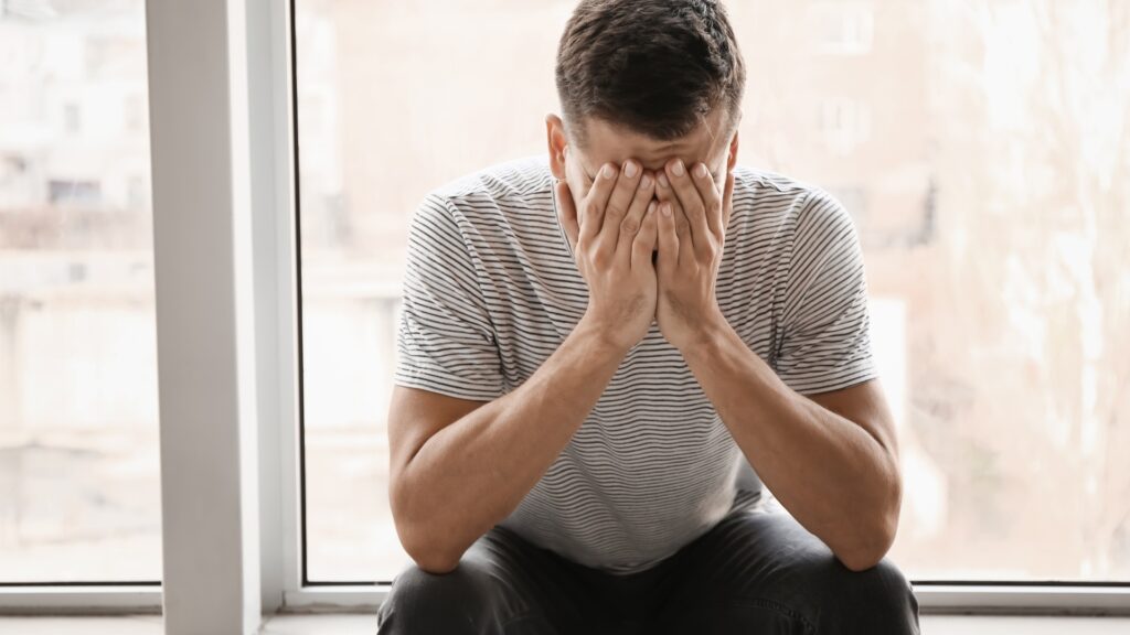 man feeling less confident in himself as he does not have new things to learn and become to improve the quality of his long-distance relationship