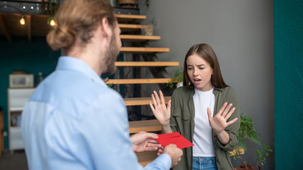 lady receiving an envelop from partner filled with cards