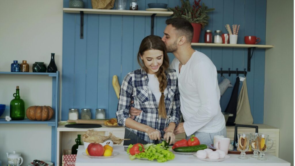 couple making a meal in lieu of their date night