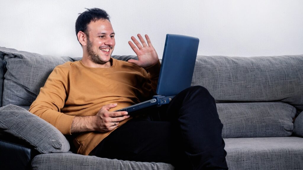 man conversing with his long distance partner during zoom games