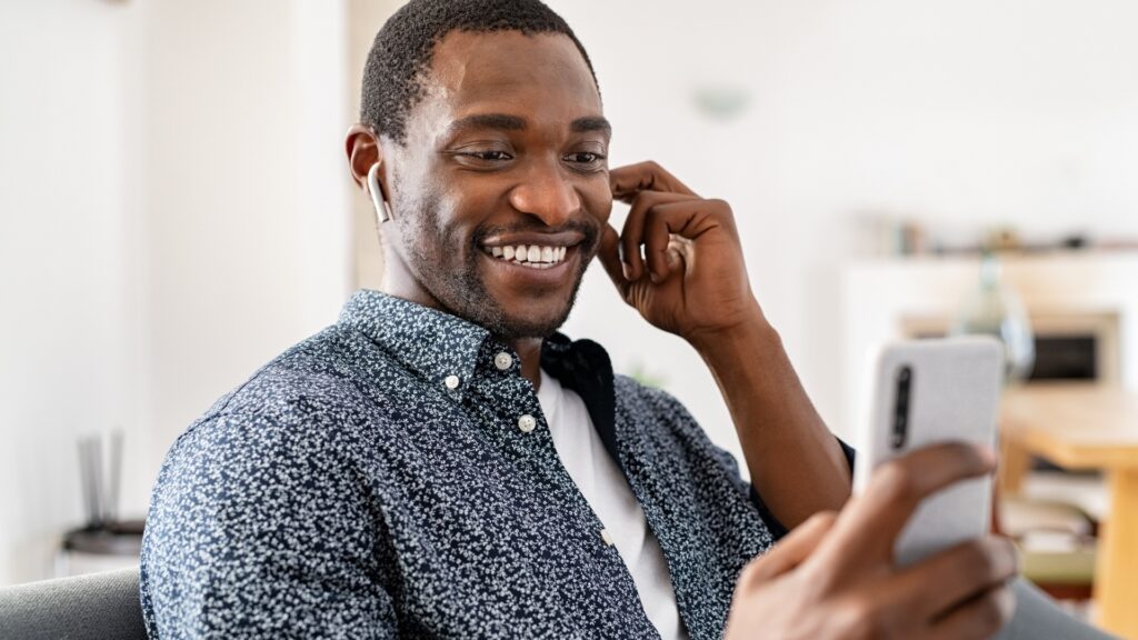 man looking at the face of his long-distance partner intentionally during a video call