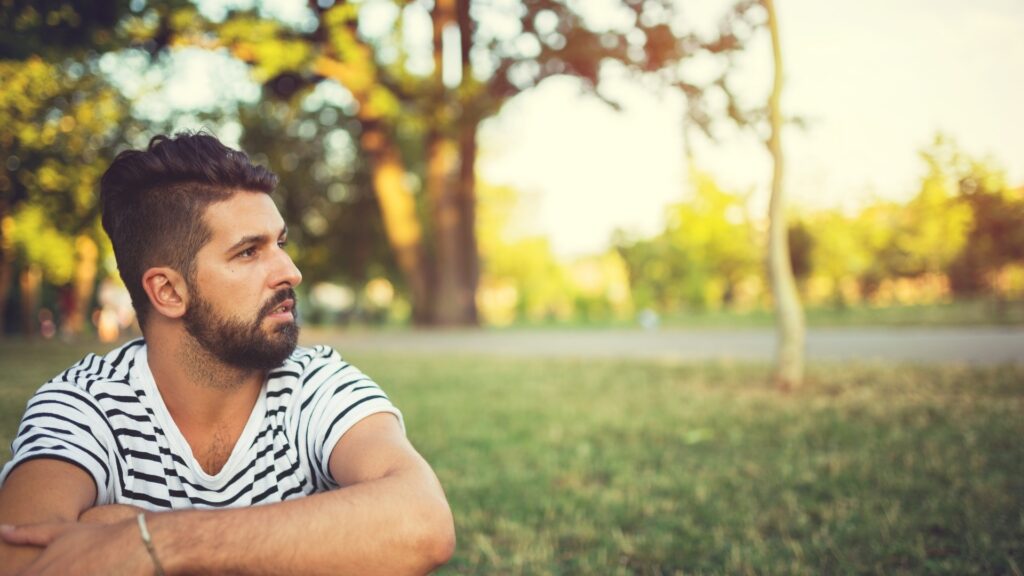 man thinking deeply about his long-distance partner 
