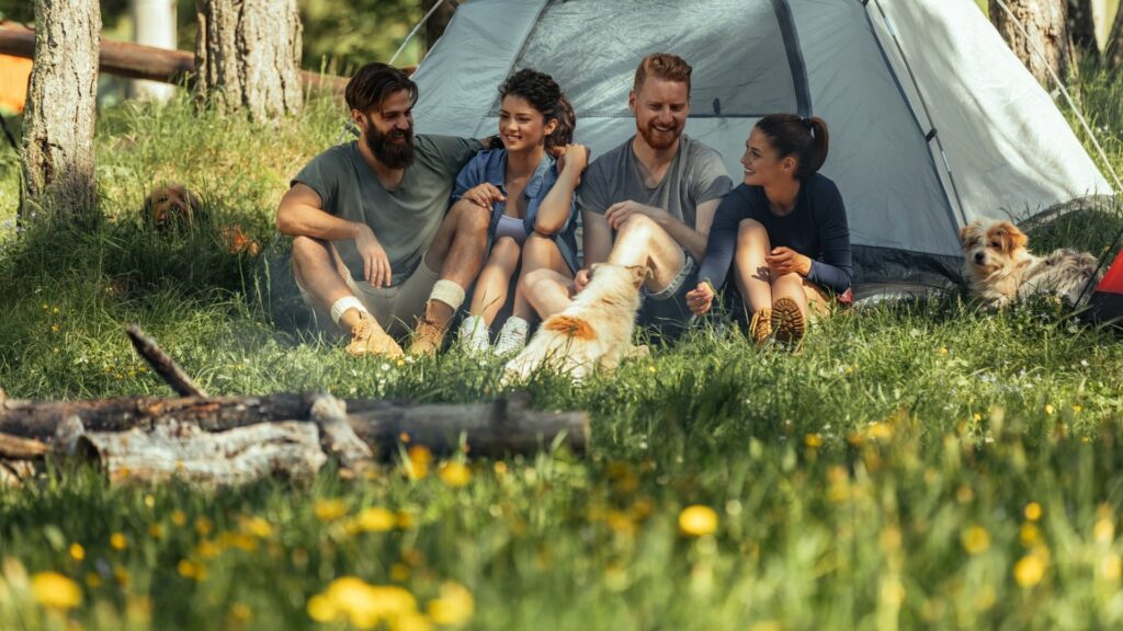 couples sitting under a tent during a weekend hang out