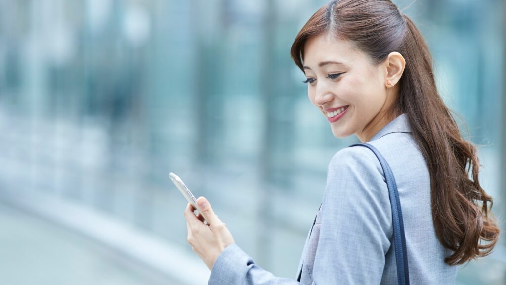 woman looking through her phone