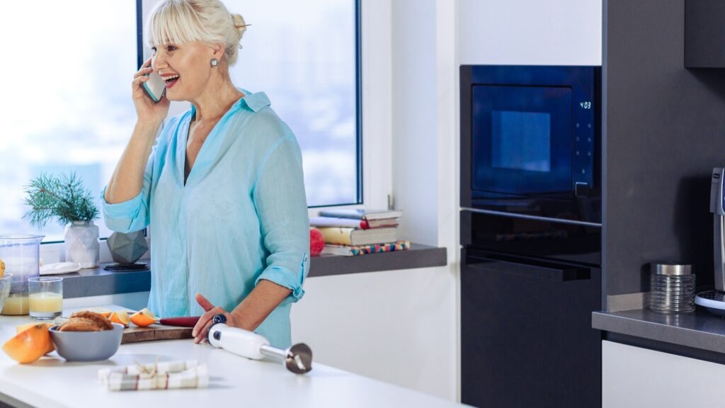 woman cooking her long distance partner's favorite meal during a virtual date