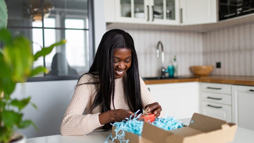 black woman opening her surprise box
