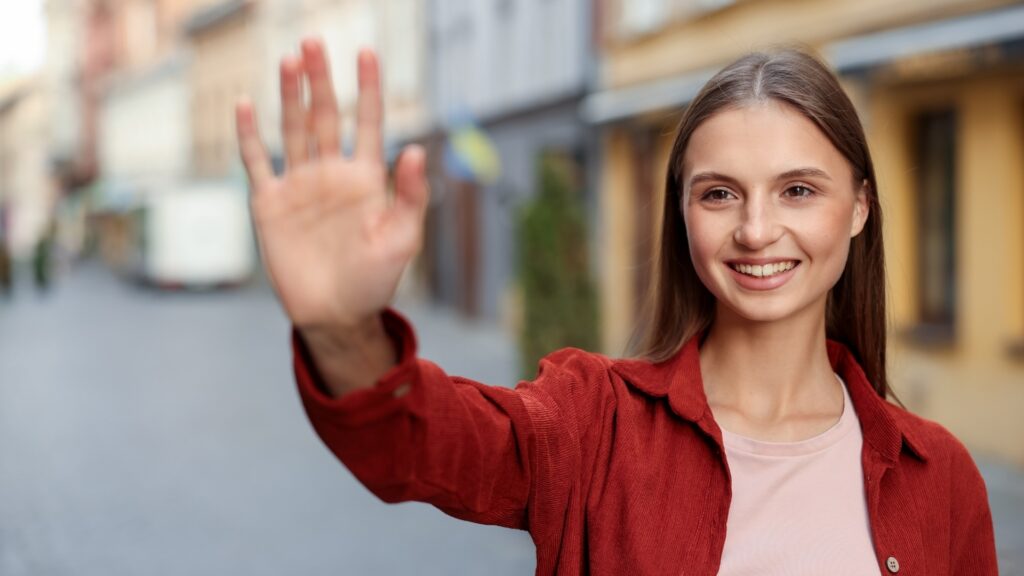 young lady waving good bye to her boyfriend at the airport