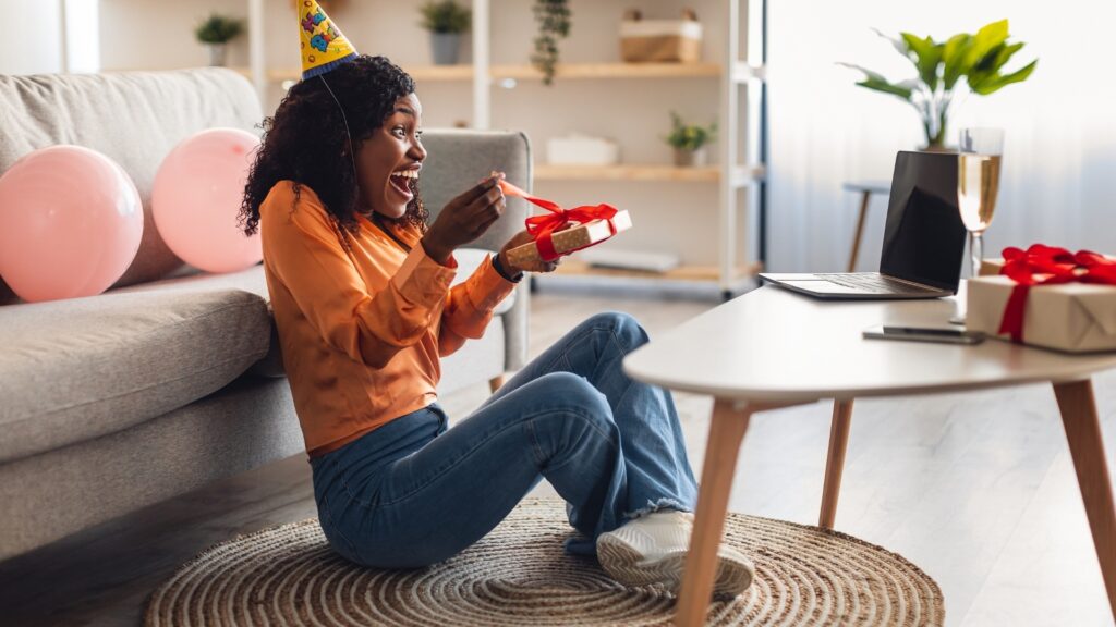 black lady opening her surprise box with excitement 