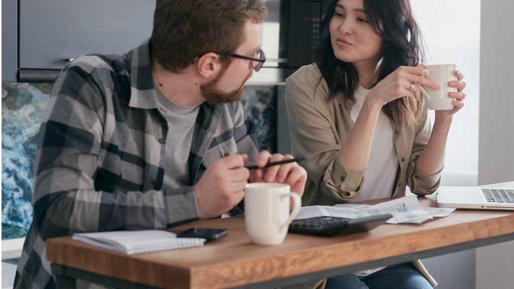 couple having a discussion before their flight is booked
