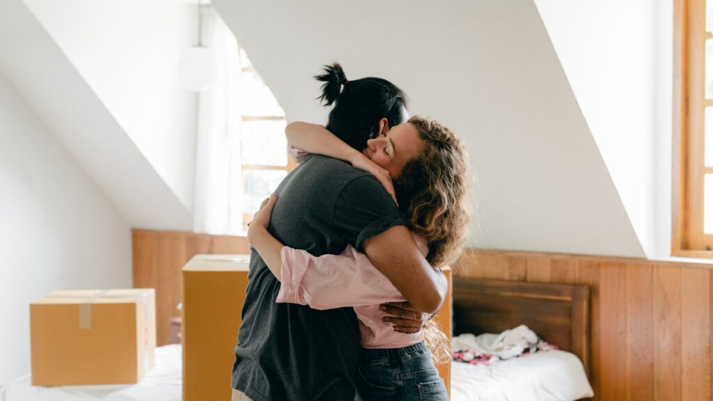 young couple hugging each other intimately after a fight